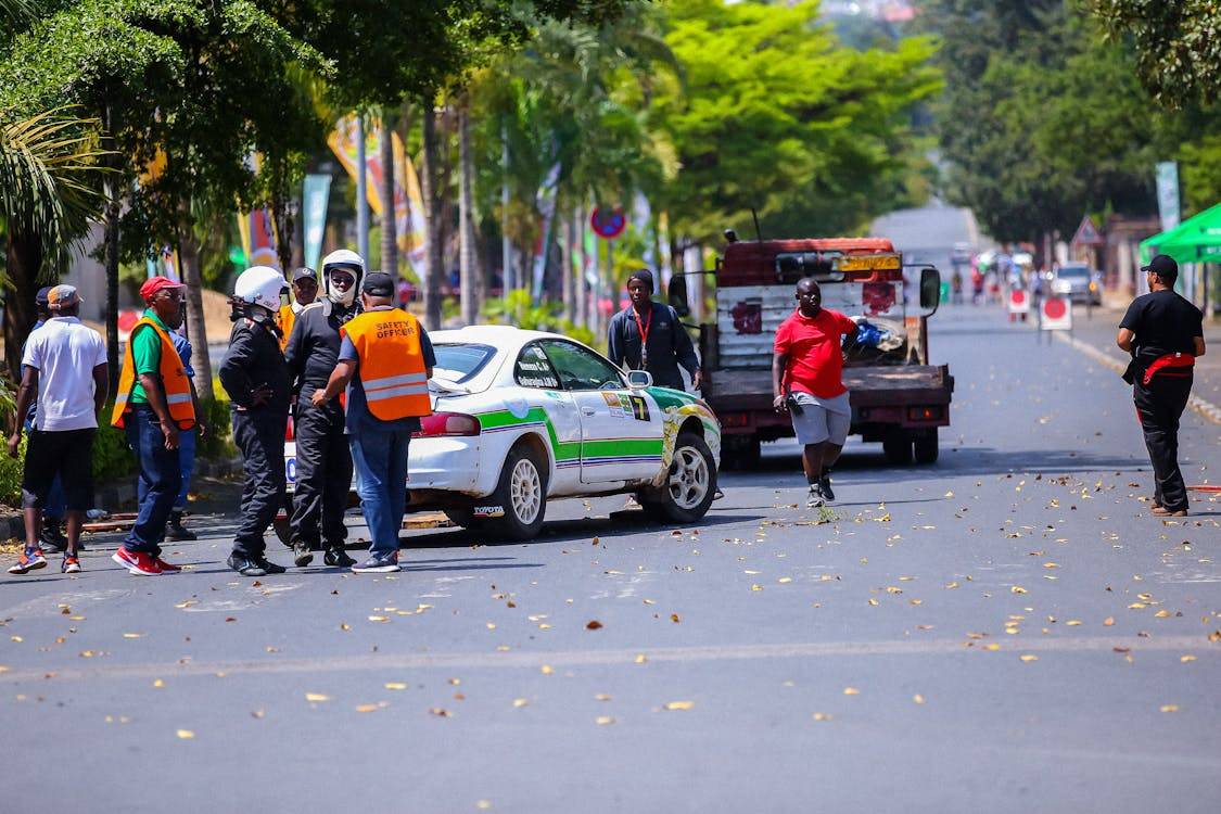 Free Photo Of Crew And Race Staff Next To Broken Toyota Celica Gt Four Standing Behind The Tow Truck